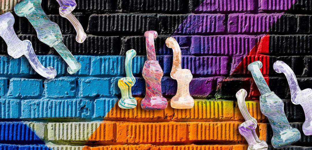 Wholesale Bubblers arranged in group of three laying on a colorful cement wall