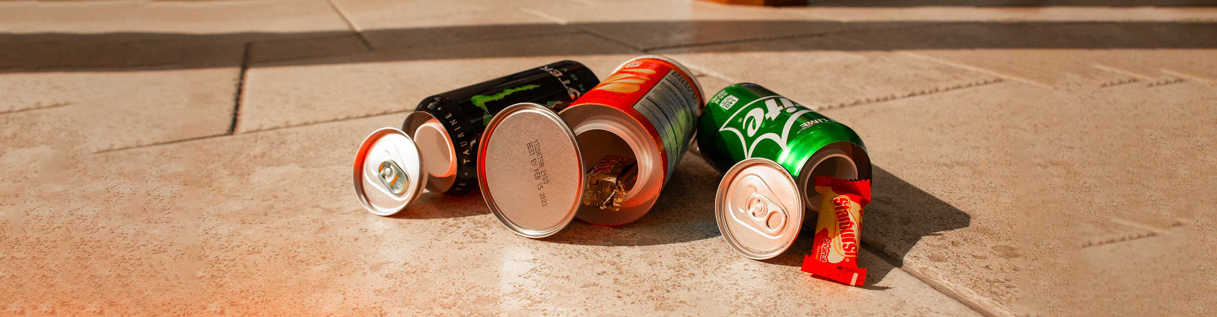 Wholesale Diversion Safe Cans laying down on office floor with all lids open and items inside.
