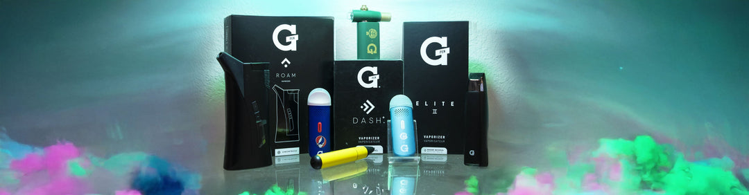 Wholesale Grenco Science G Pen Dash, Micro +, Roam, Connect, Elite 2 standing on glass desk in office area with normal lighting