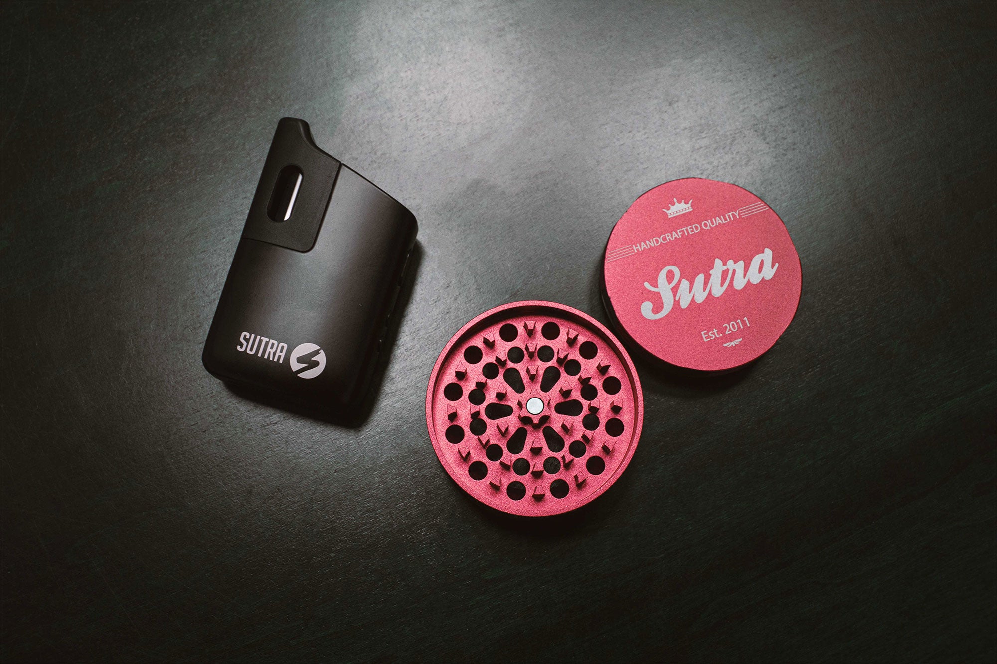 Wholesale Grinder and device laying down on a black office table 