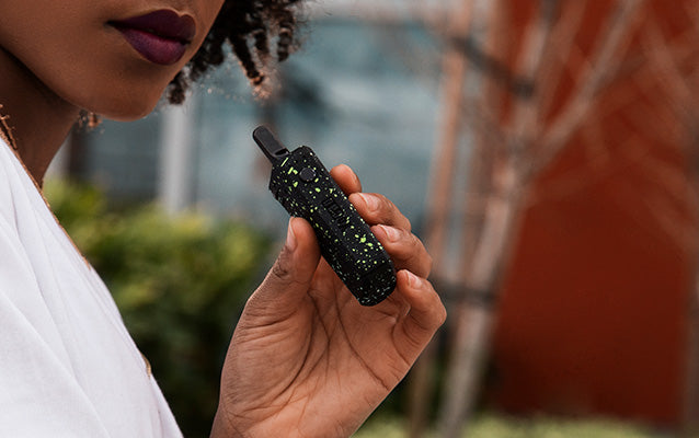 woman holding Wulf UNI outside with building in the background